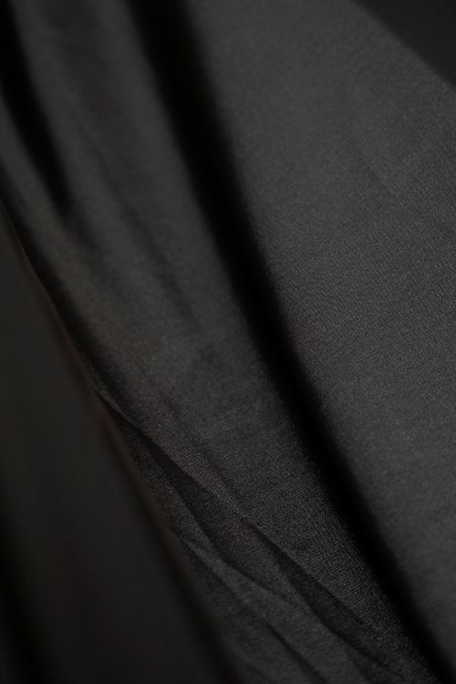 Free Detailed close-up view of black satin fabric showcasing its soft and textured surface. Stock Photo
