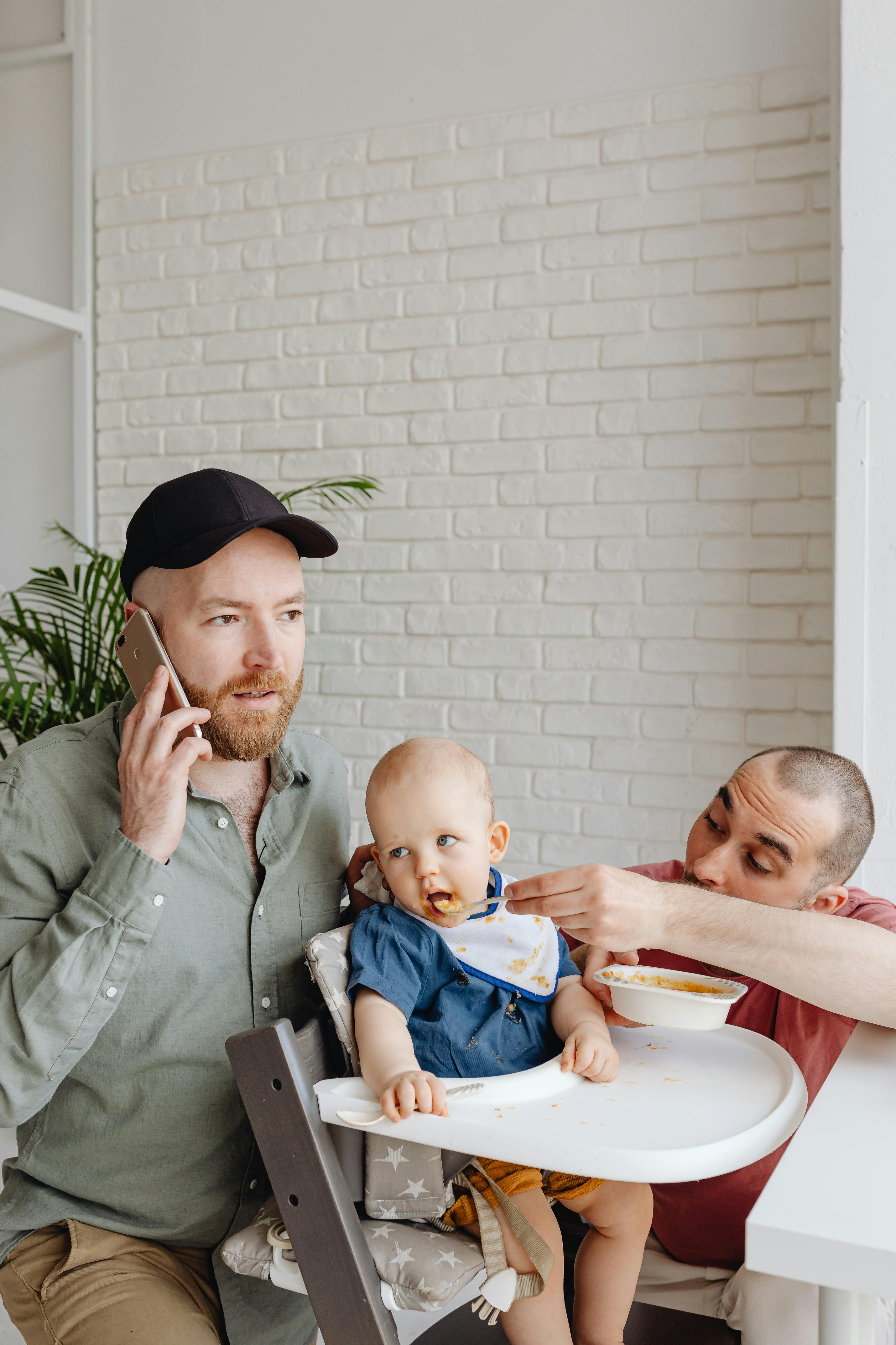 a man feeding a boy