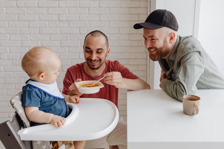 Men Feeding Their Child