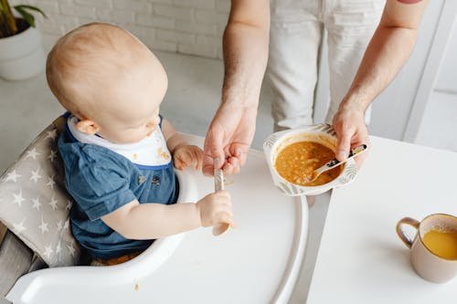 A Boy Holding a Spoon