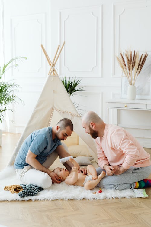 Fathers Playing with Their Baby on the Carpet