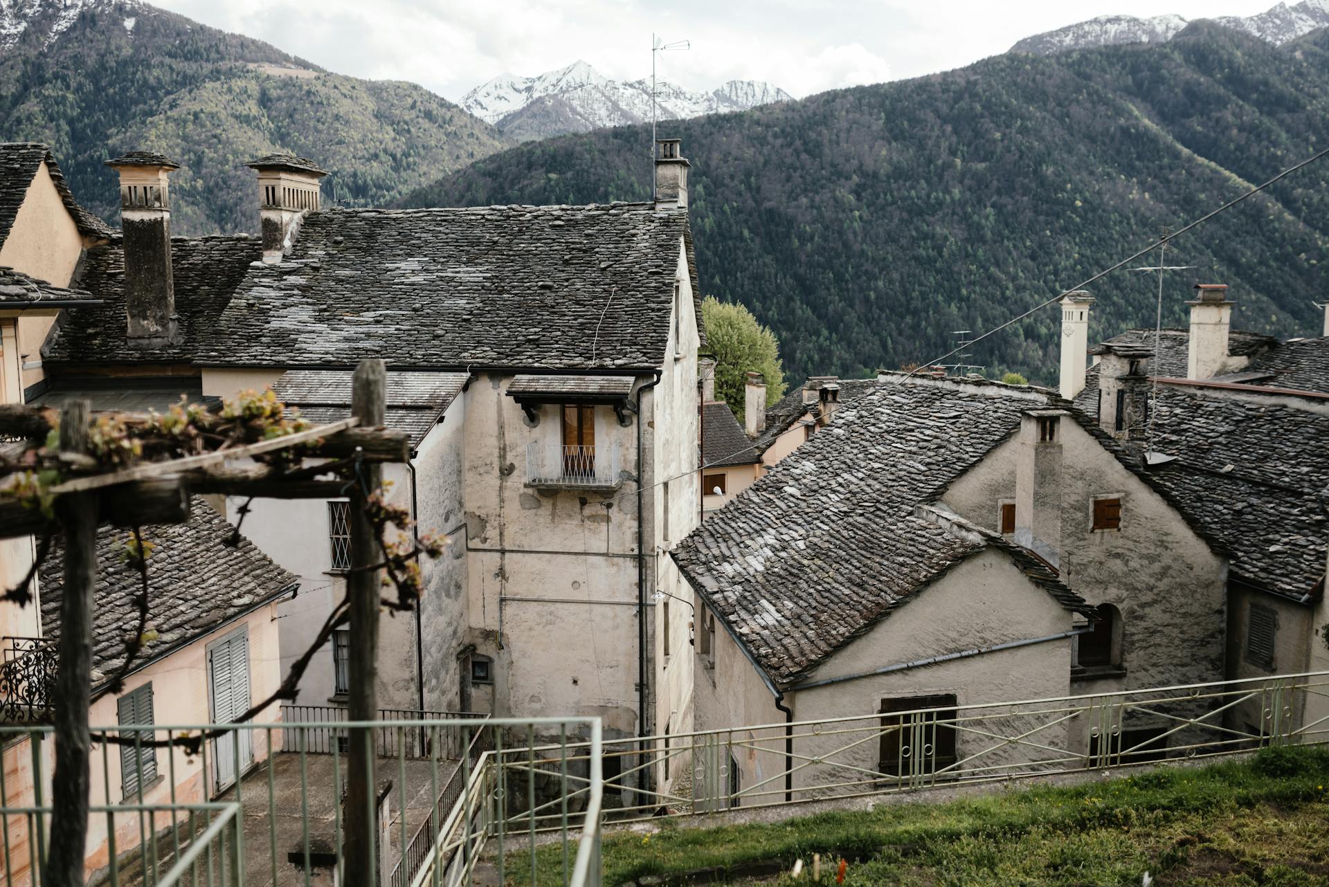 Charming view of a rural village nestled in the mountains, showcasing traditional slate roof architecture.