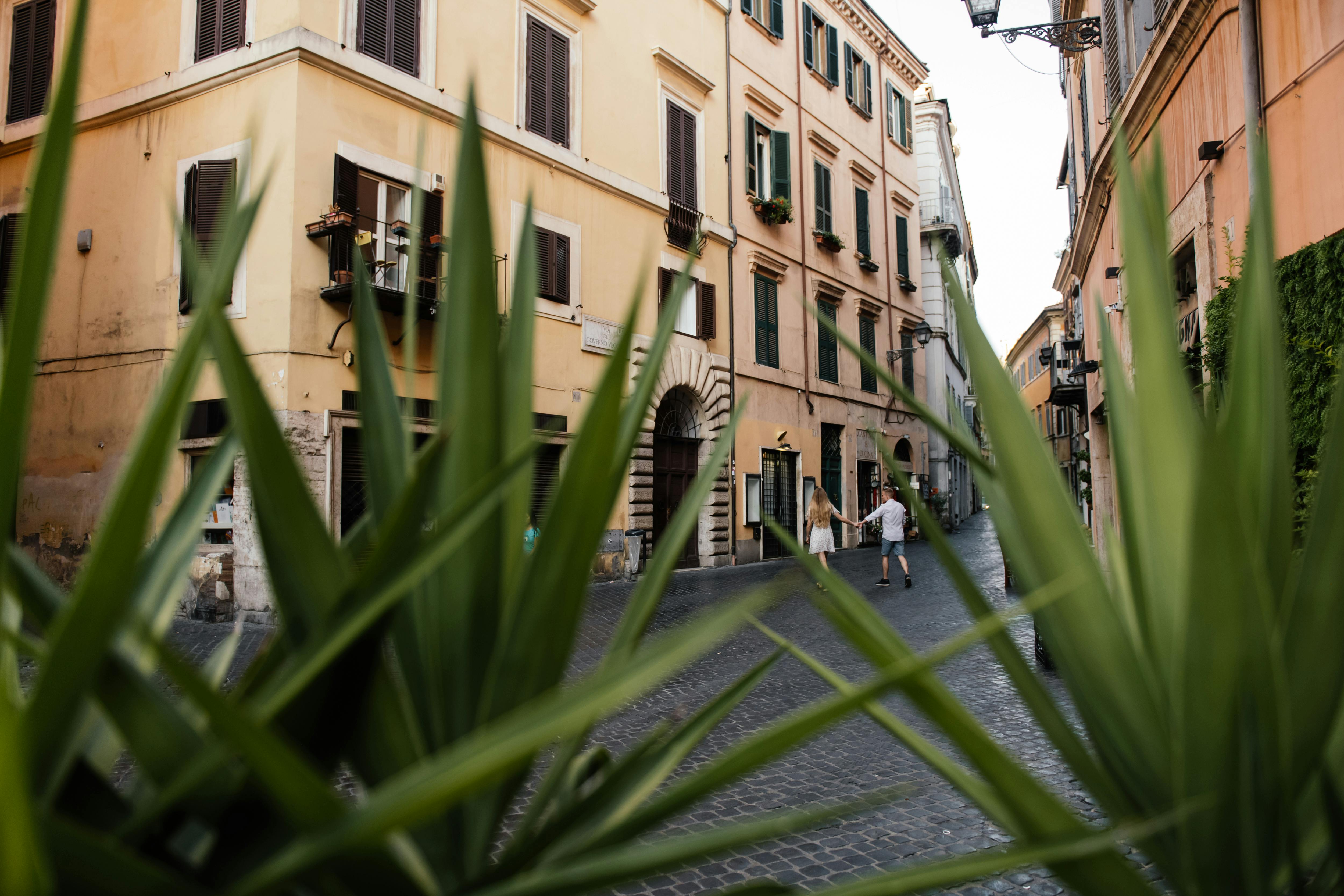 couple walking hand-in-hand on a charming European street - couple trips on a budget