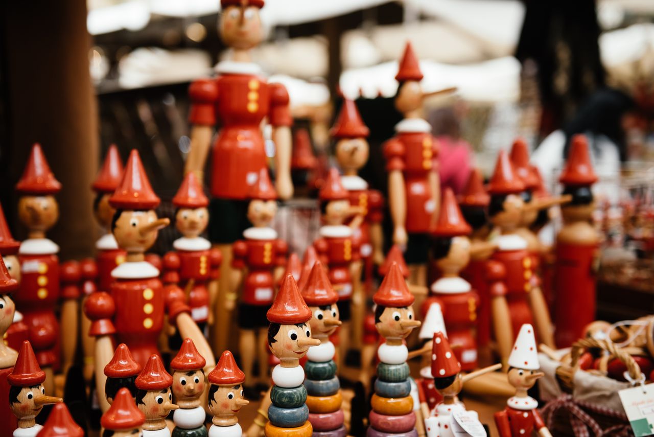 close up of handmade wooden pinocchio toys at a market perfect for tra