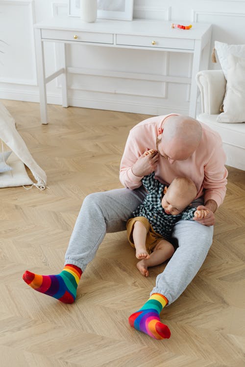 Father Sitting on the Floor with His Baby