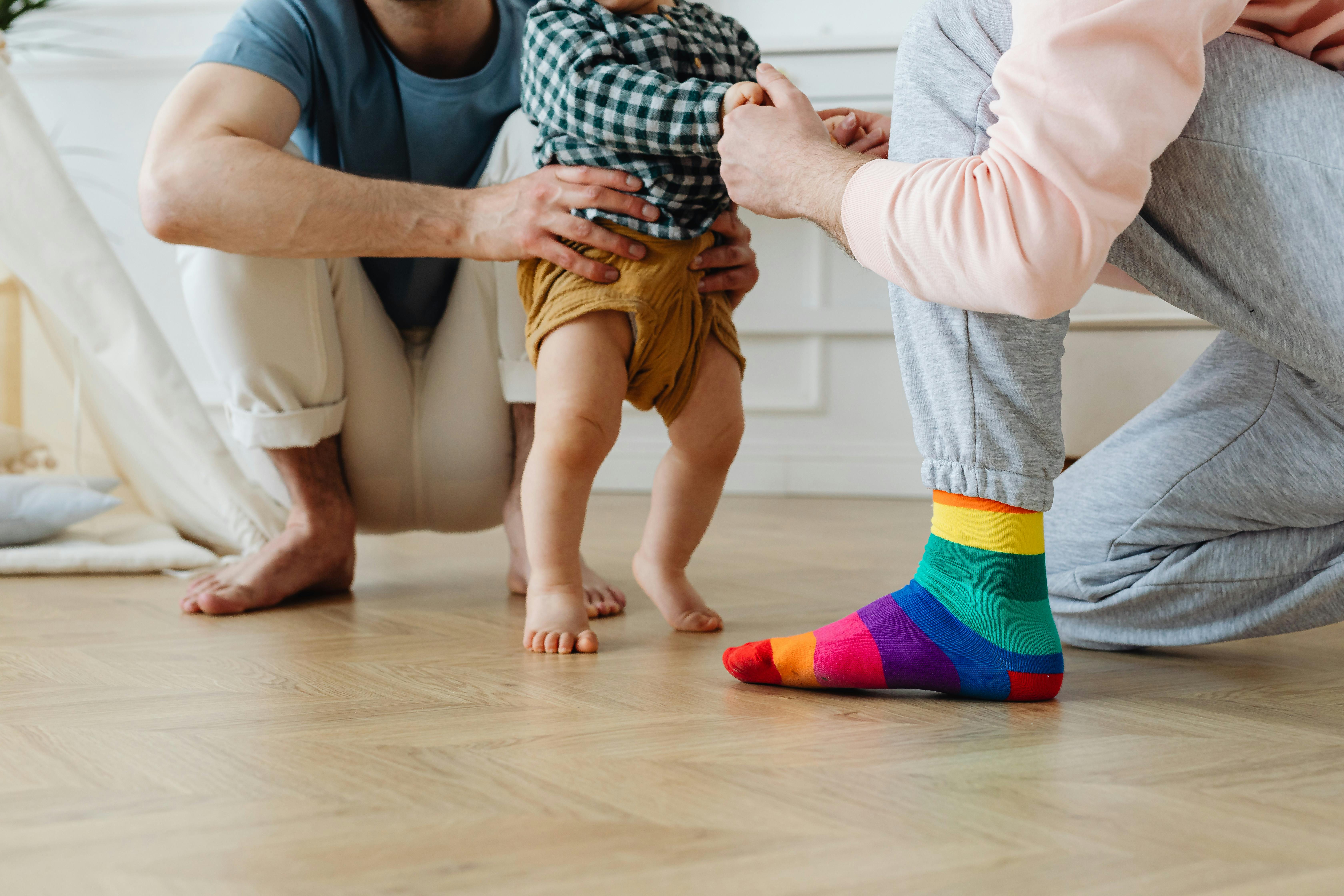 couple teaching a baby to walk