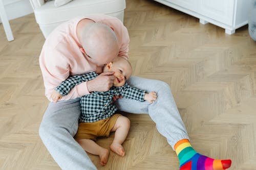 Free A Man in Pink Sweater Pinching Cheeks of His Son Stock Photo