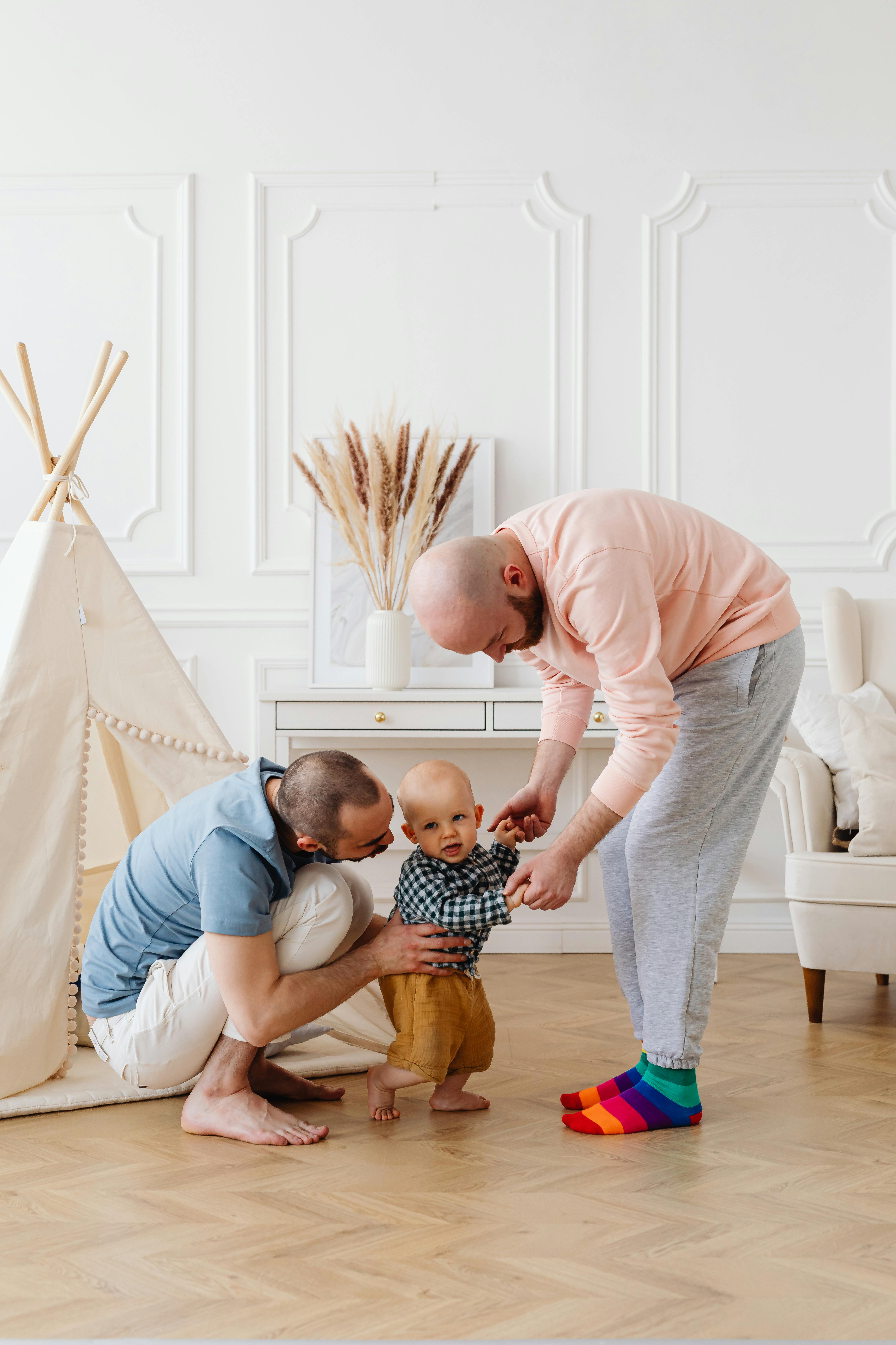 a same sex couple guiding their son