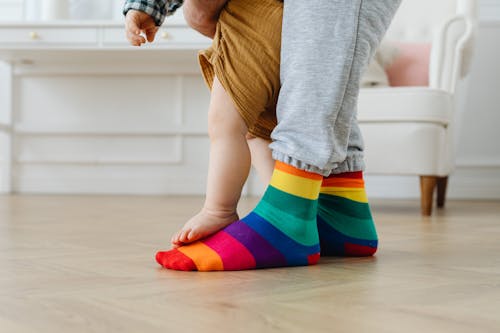 Baby Taking First Steps Standing on His Fathers Feet