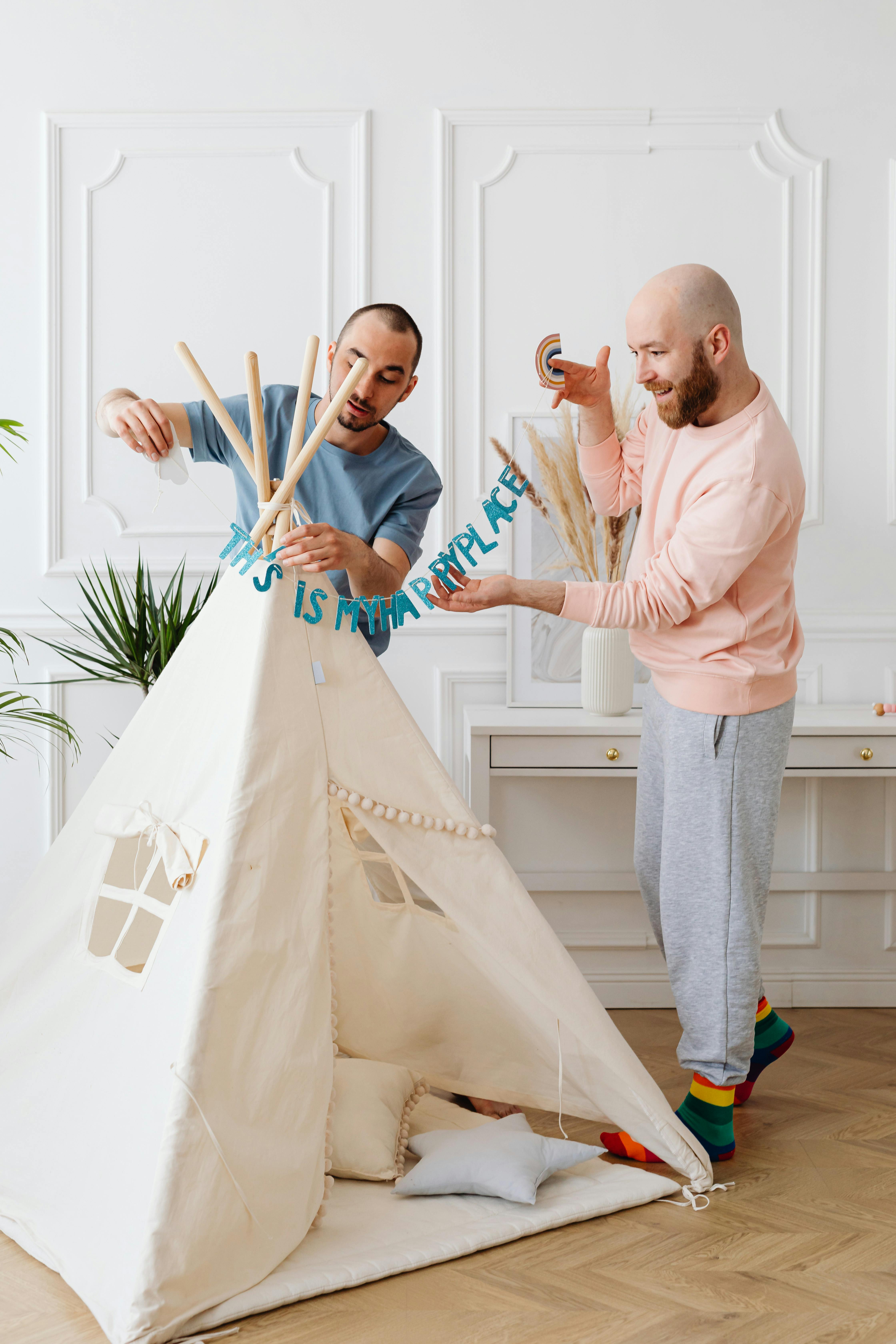 men standing while fixing the teepee