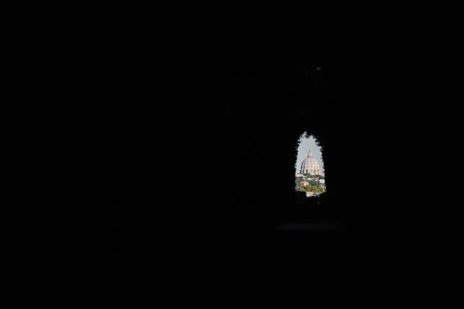 Iconic dome of St. Peter's Basilica framed through a keyhole in Rome, Italy.
