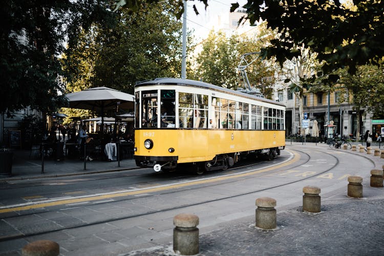 Yellow And White Tram On Road