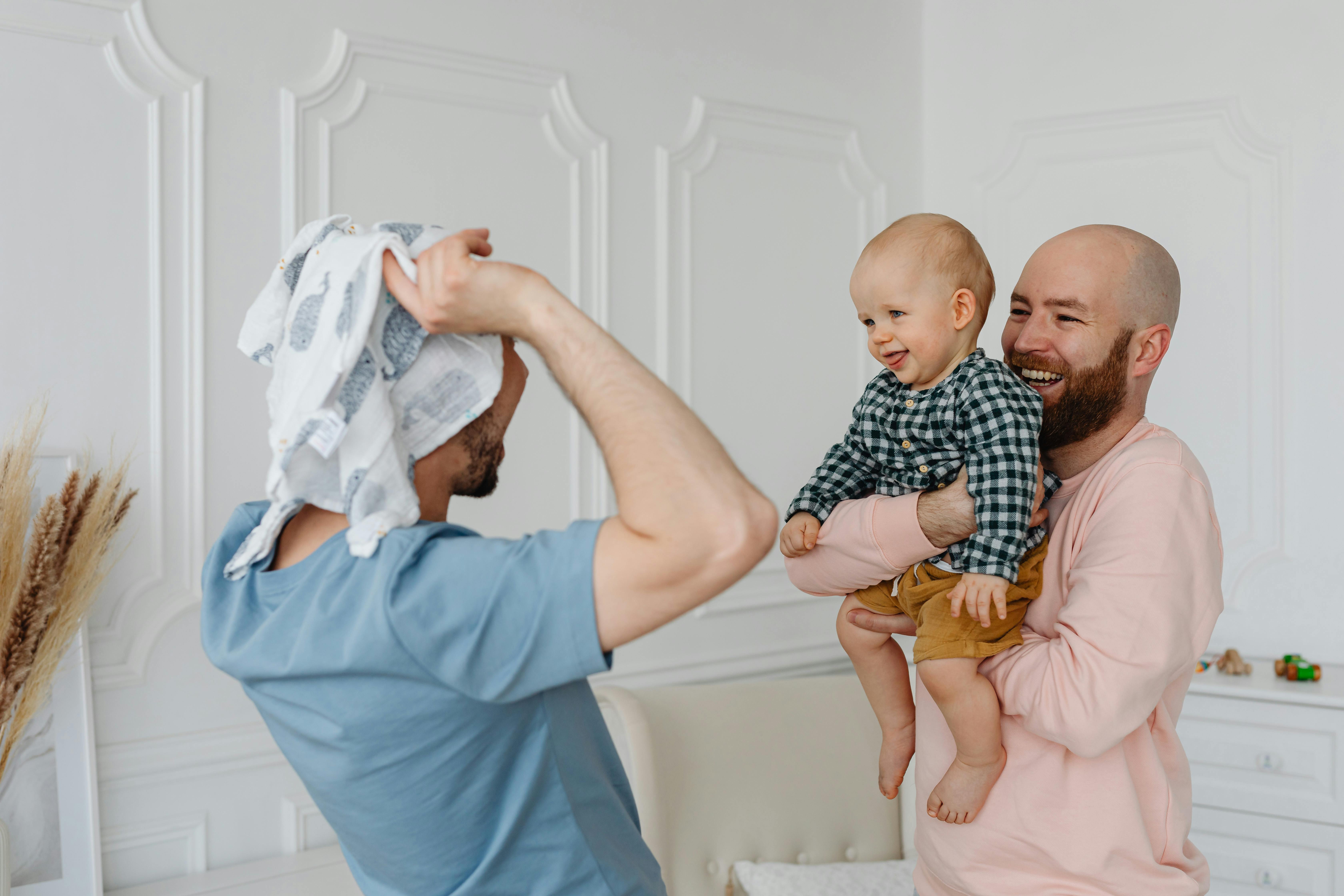 a same sex couple playing with their son