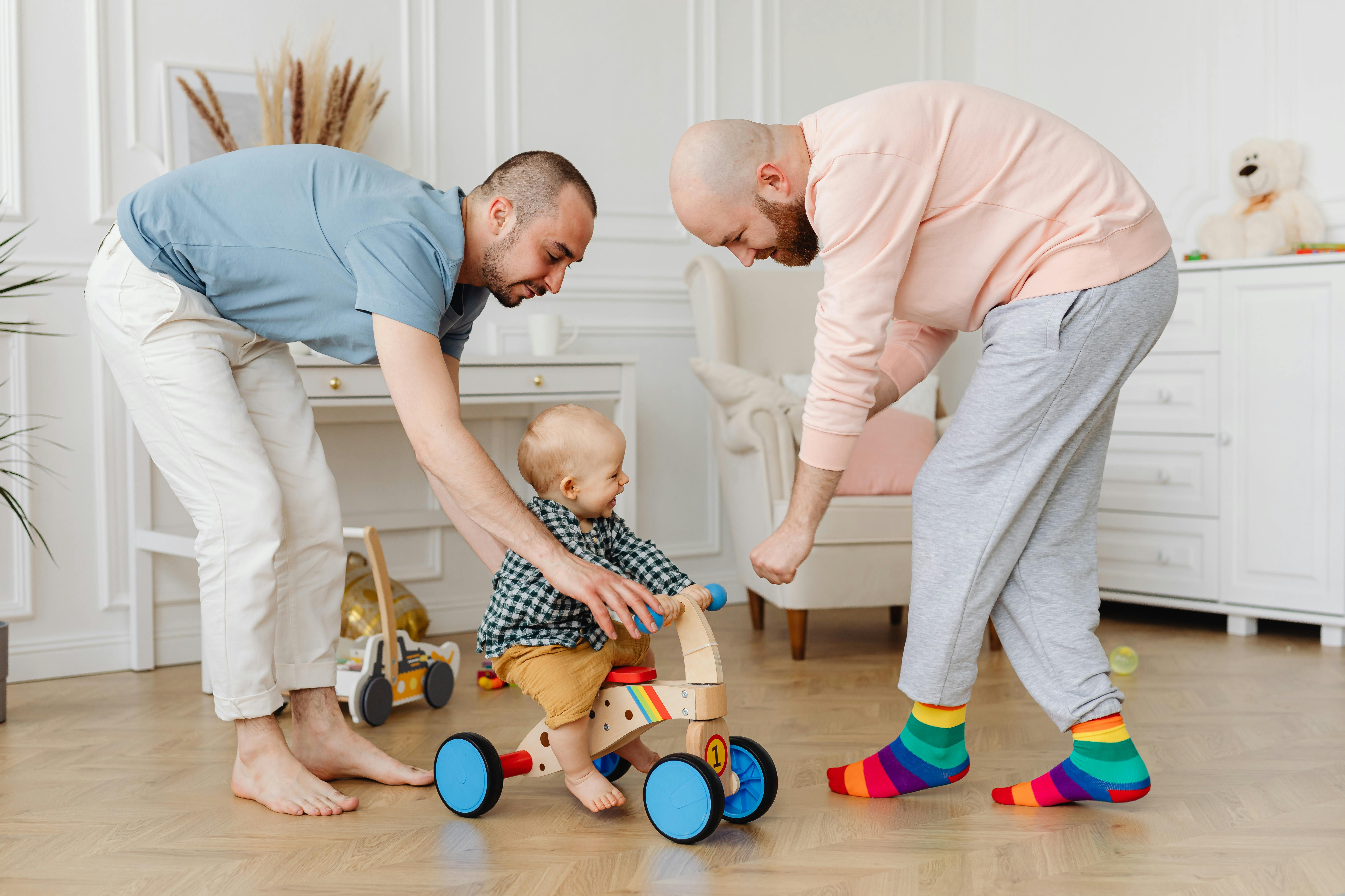 two men playing with the baby