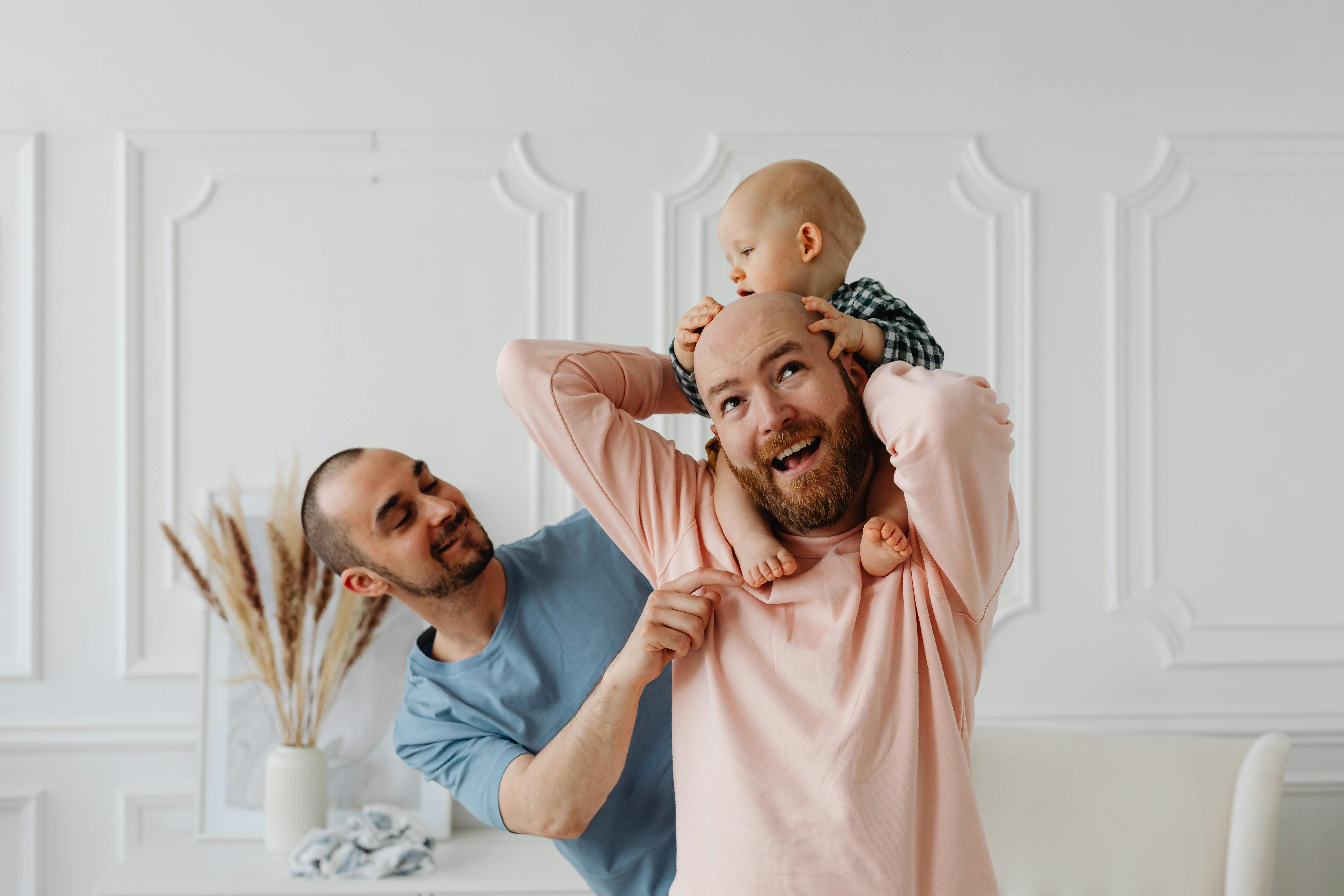 a couple playing with their baby