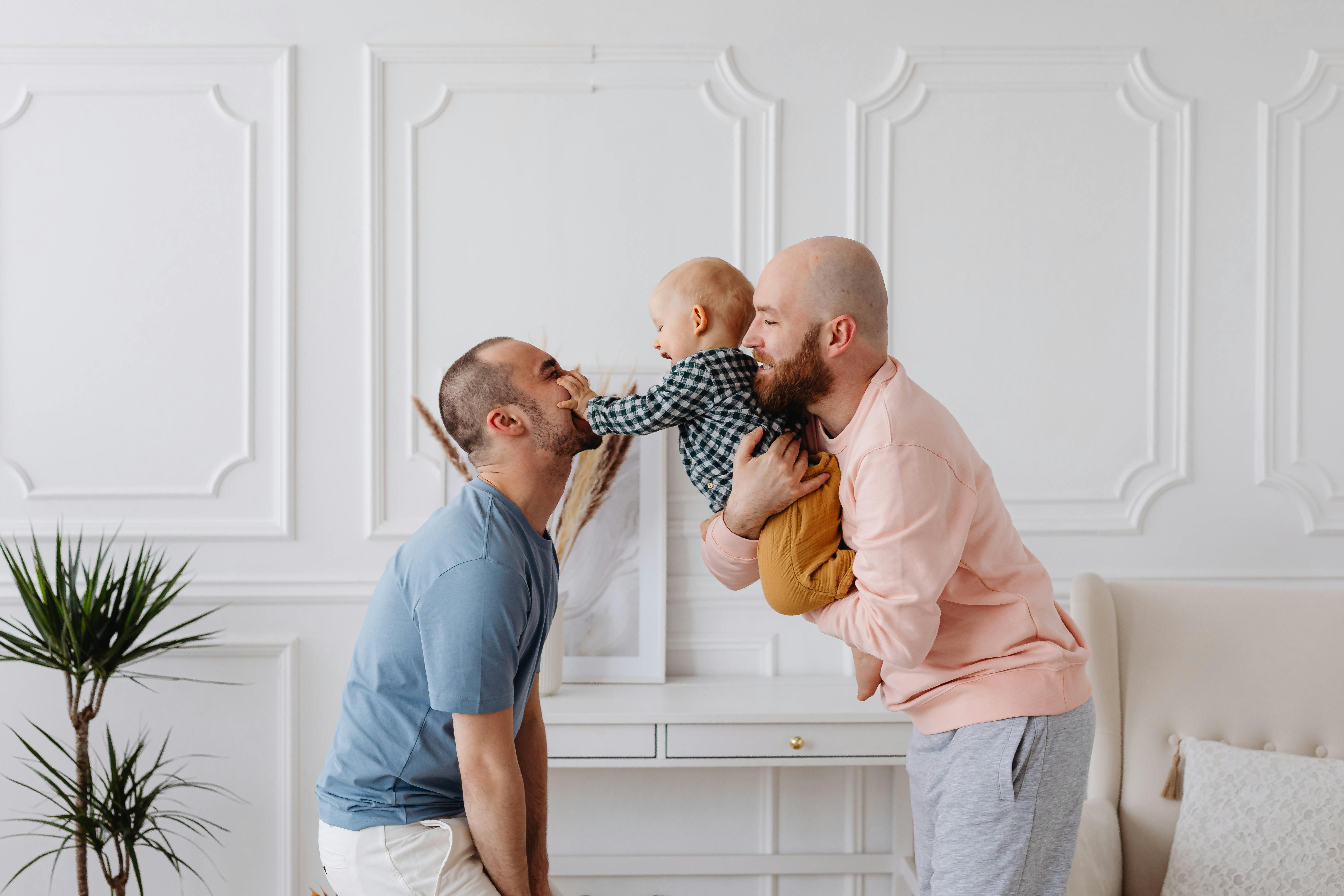 two men playing with the baby