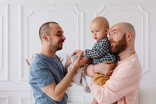 Free A Same Sex Couple Taking Care of Their Baby Boy Stock Photo
