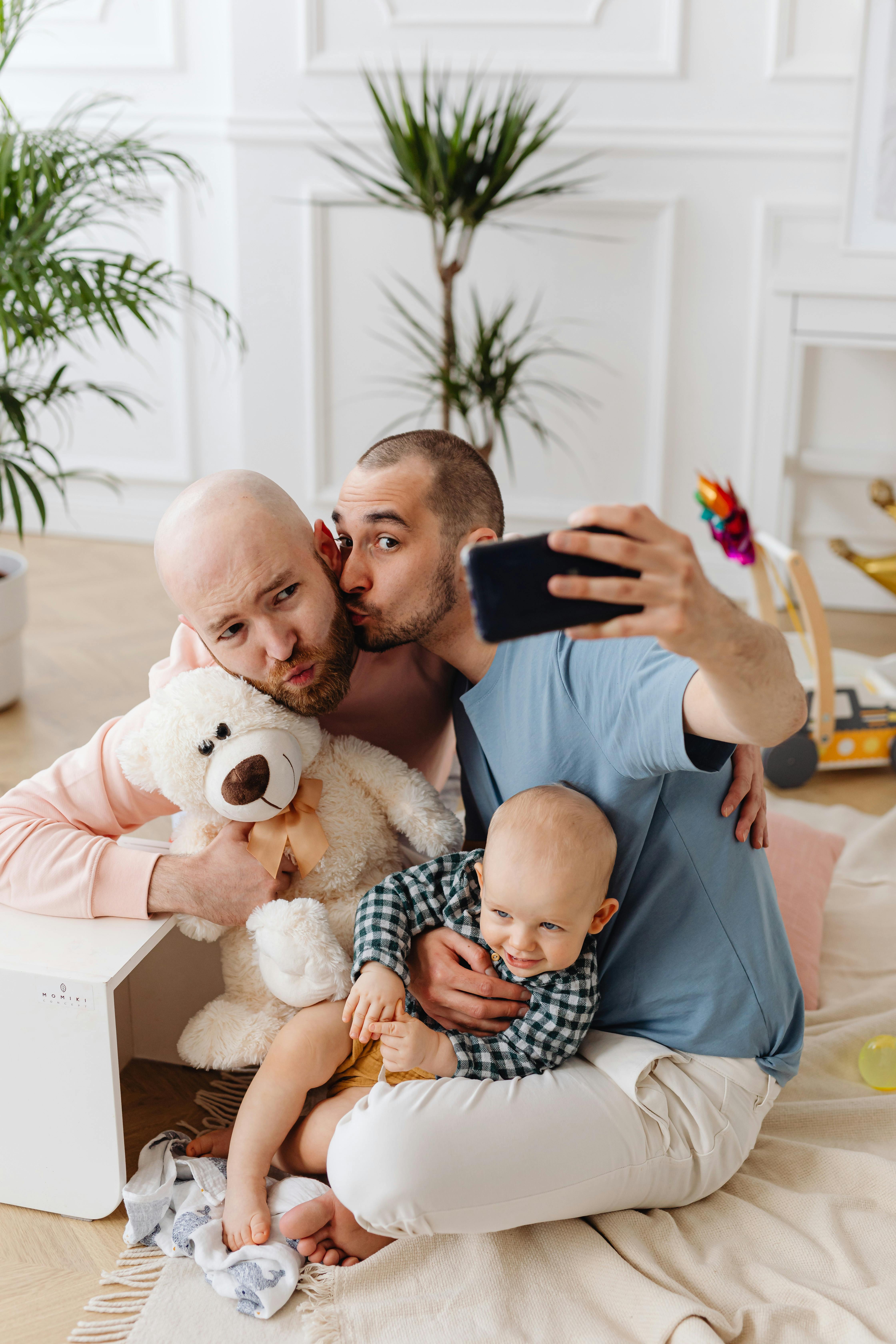 a couple kissing each other while taking selfie