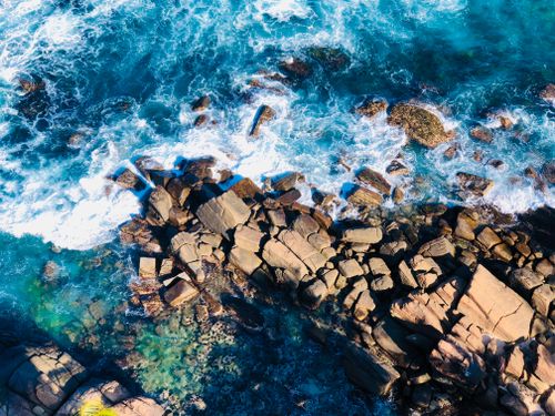 Free Stunning aerial shot of waves crashing against the rocky coastline of Dondra, Sri Lanka. Stock Photo
