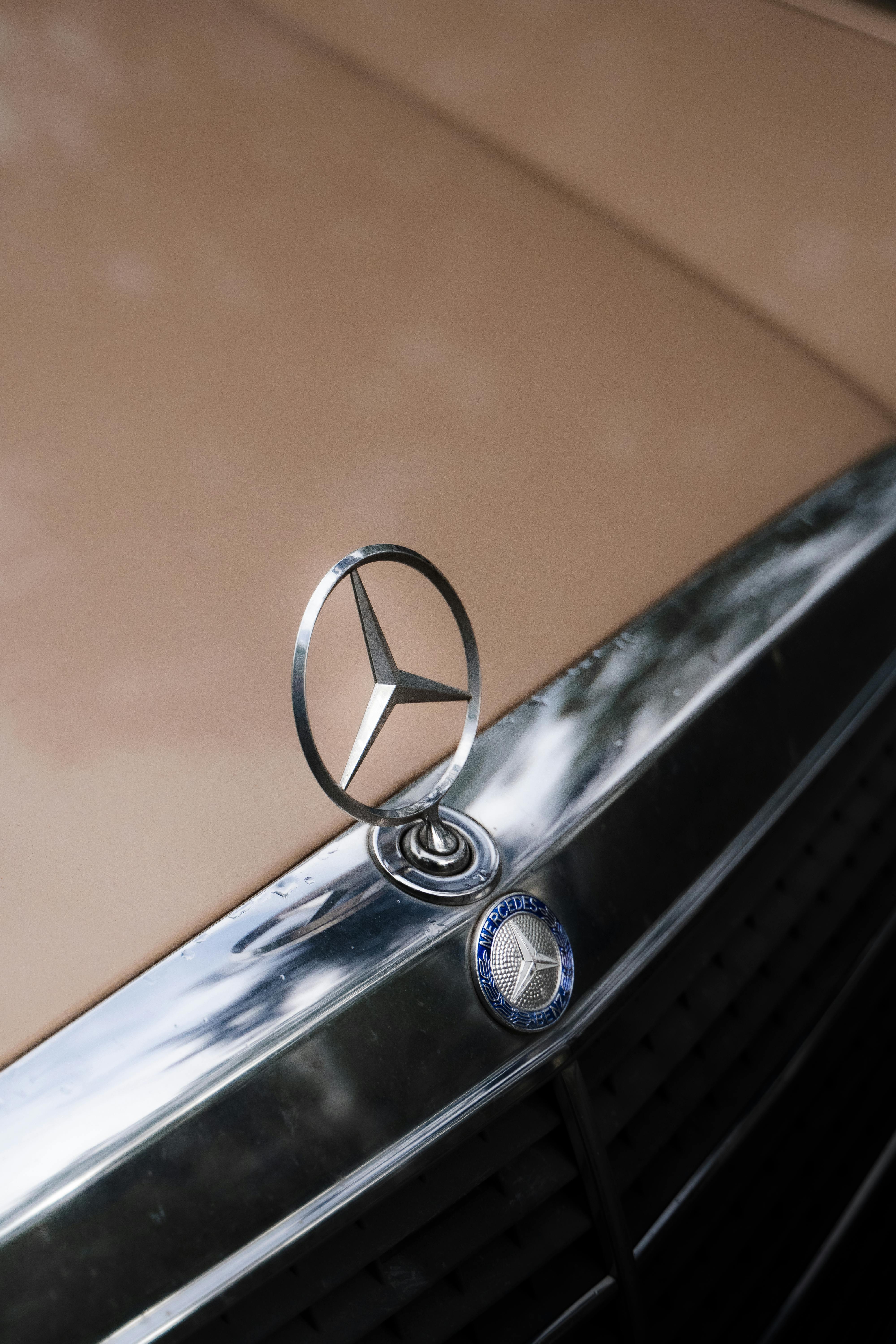 Silver Mercedes Benz Logo on Black Surface · Free Stock Photo