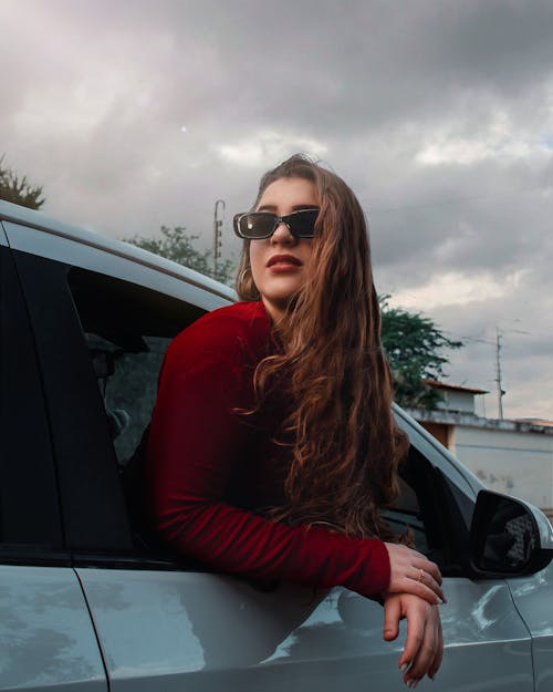 A Woman in Red Sweater while Wearing a Sunglasses