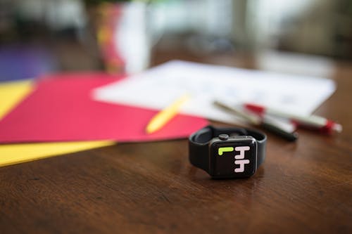 A  Smart Watch on a Brown Wooden Table