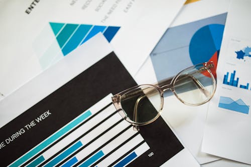 Silver Framed Eyeglasses on White Paper