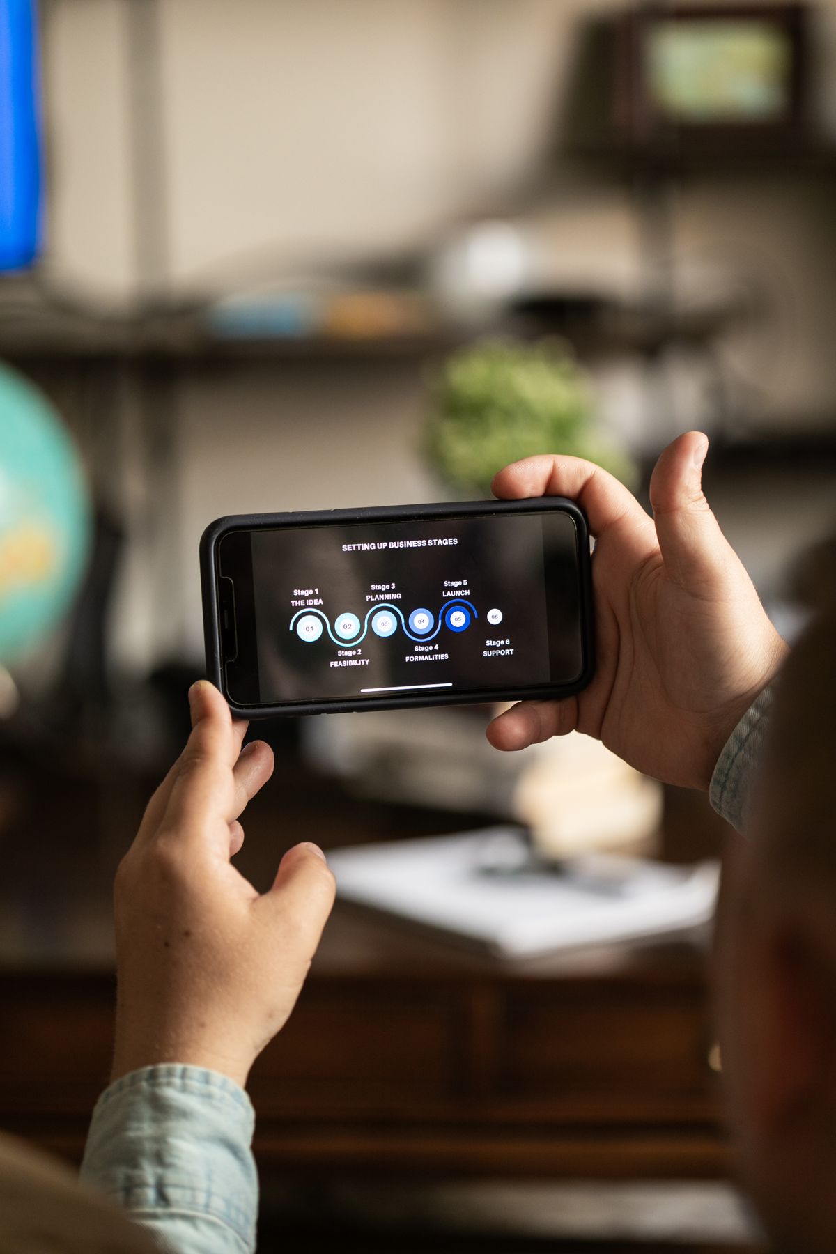 Person holding a smartphone with analytics charts representing acquisition and token conversion measurement for vertical series