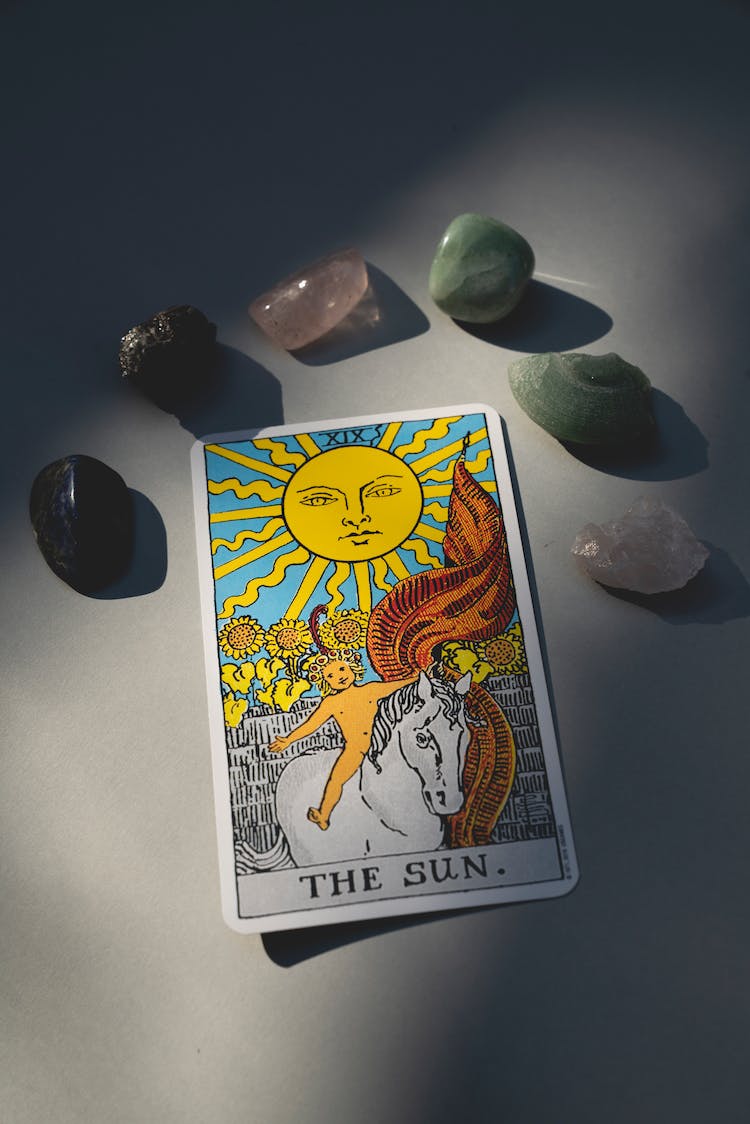 Tarot Card Surrounded With Healing Stones
