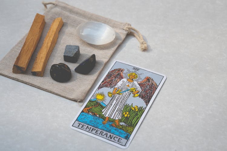 A Tarot Card, Healing Crystals And Sticks Of Palo Santo