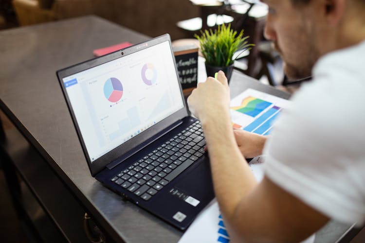 Person Using Black Laptop On Table