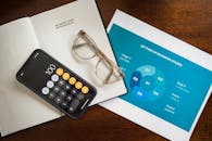 Calculator and Eyeglasses on Document Papers