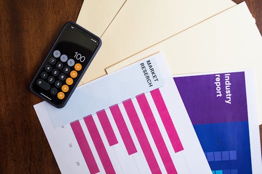 Flat lay of smartphone and market research papers on wooden table for business analysis.