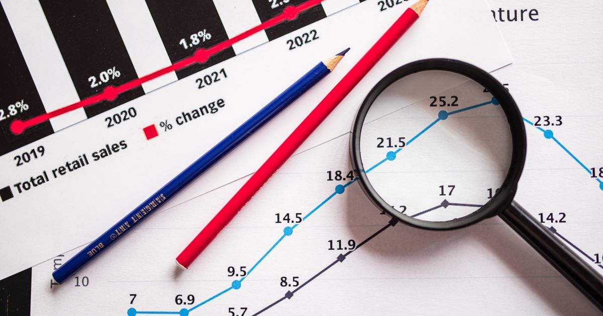 Magnifying glass over charts, representing scrutiny of trust in AI search answers.