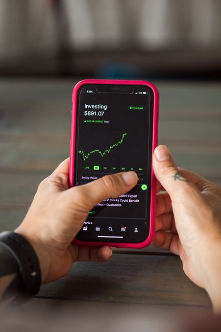 stock investor looking at rising chart smartphone