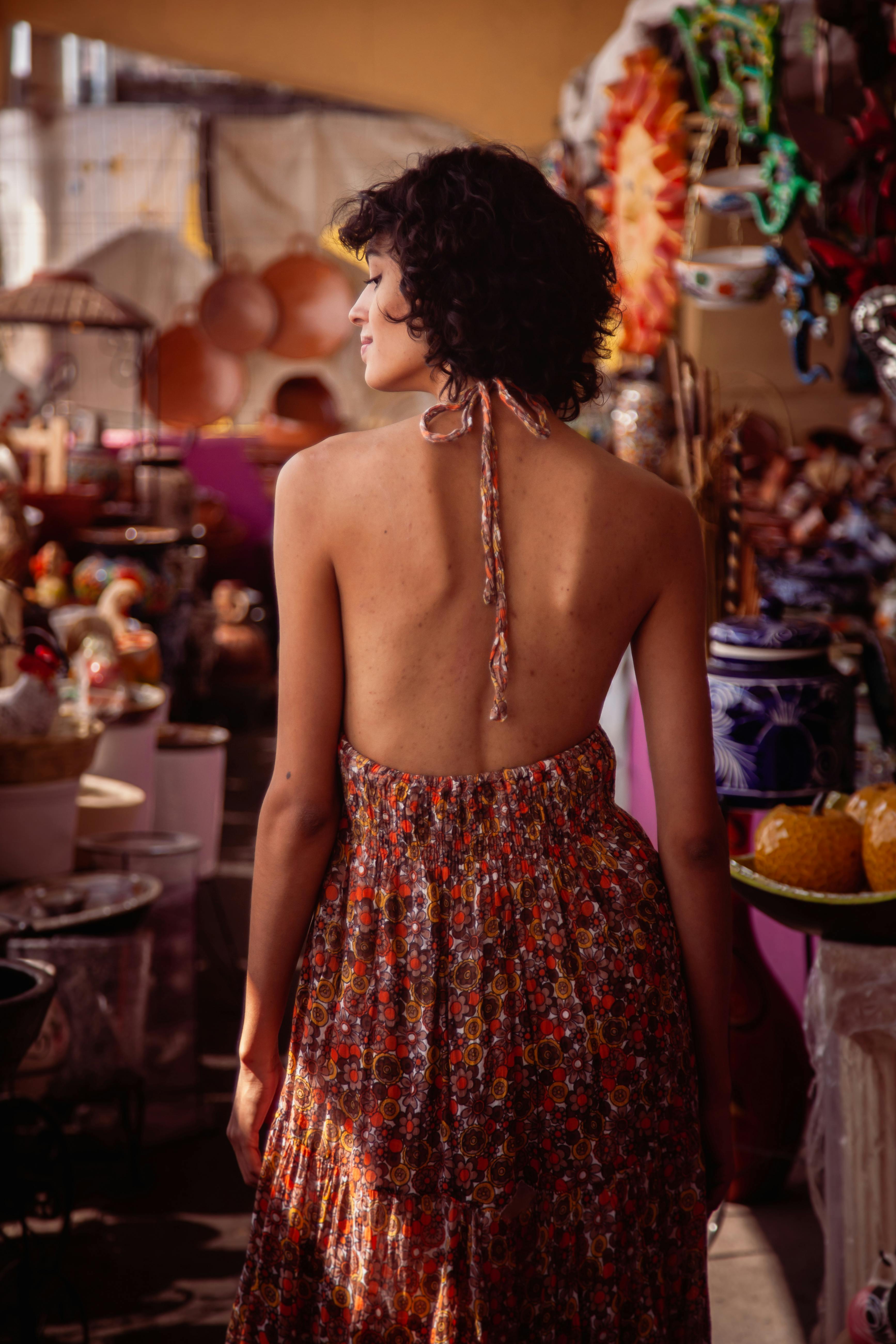 Woman in Orange and Black Tube Dress Standing in Front of People · Free Stock Photo