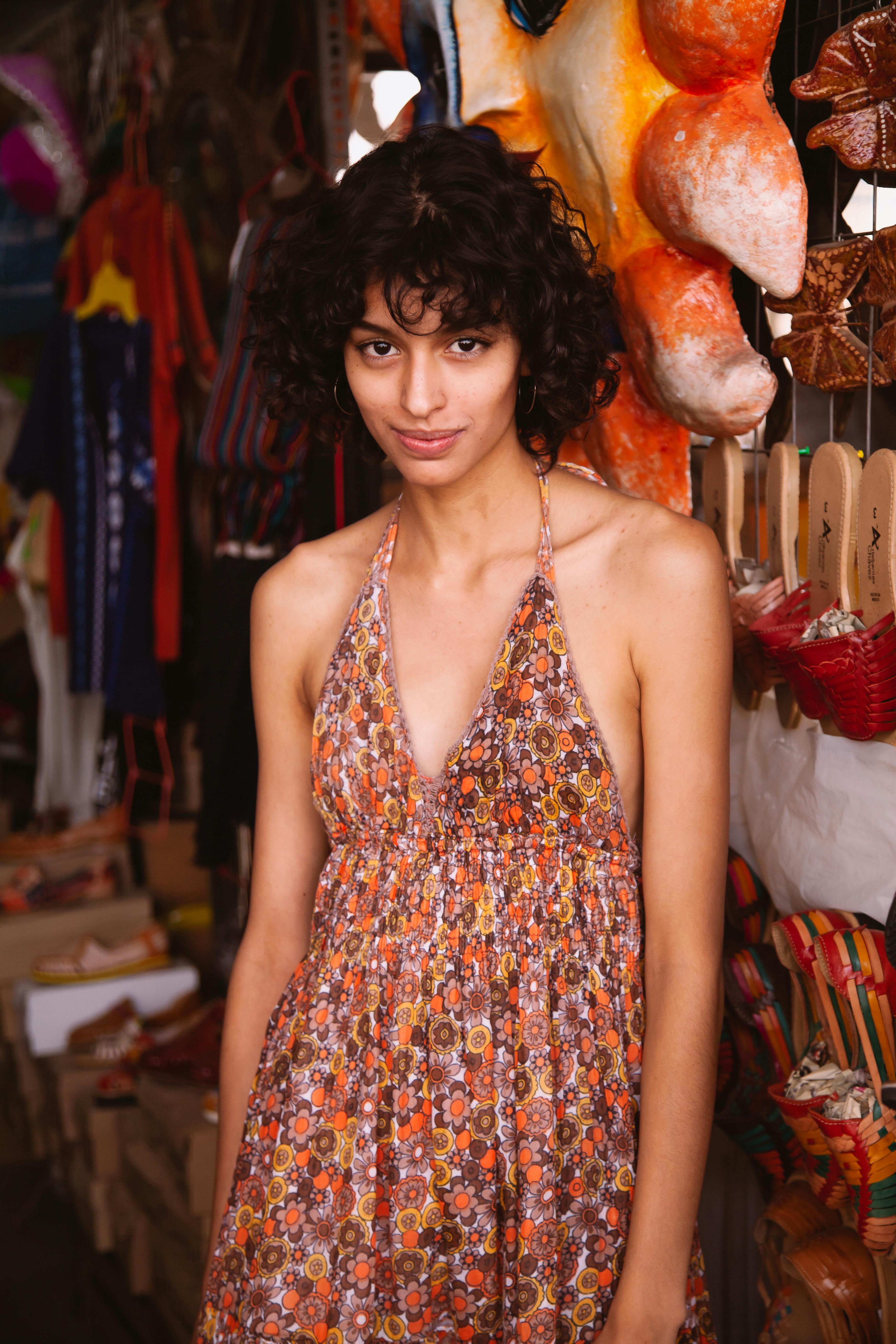 Woman in Orange and White Floral Spaghetti Strap Top