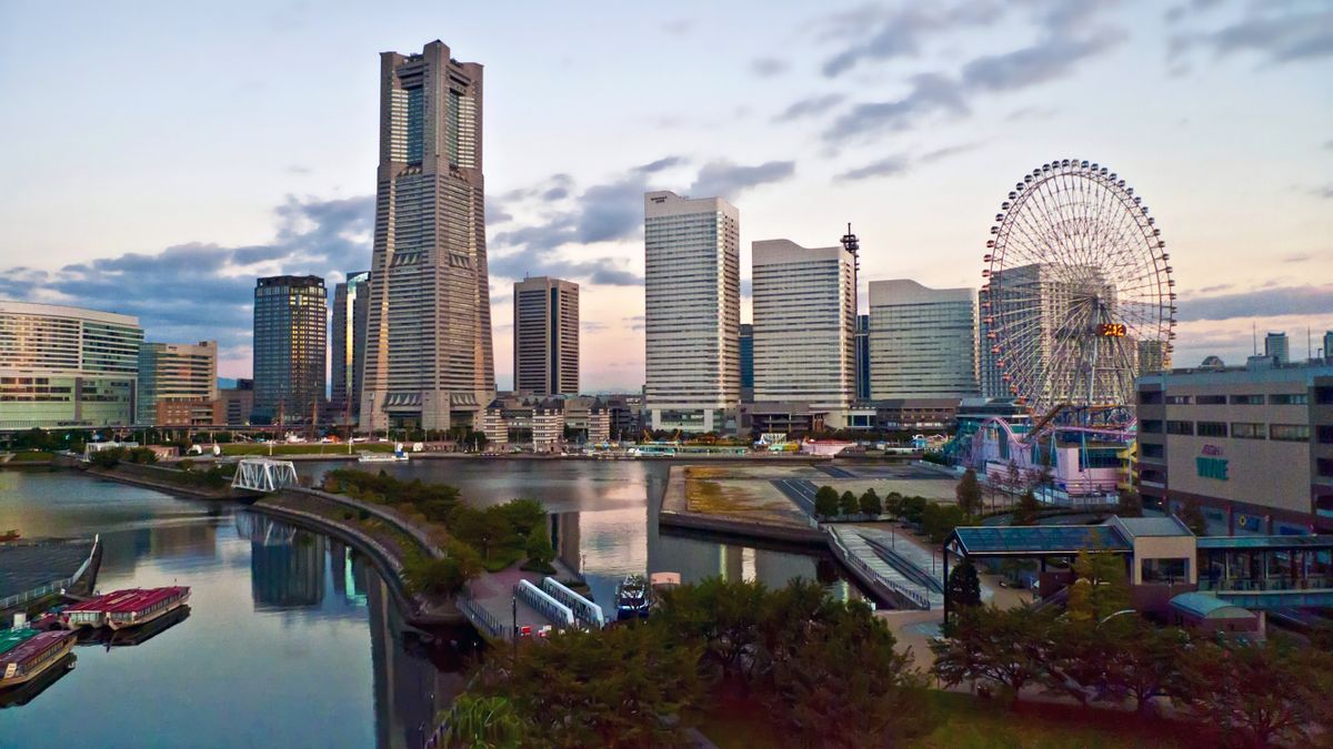 Yokohama Minato Mirai skyline featuring Landmark Tower and the Cosmo Clock 21 Ferris wheel illuminated at dusk