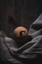 Fresh pumpkin placed near light fabric on floor