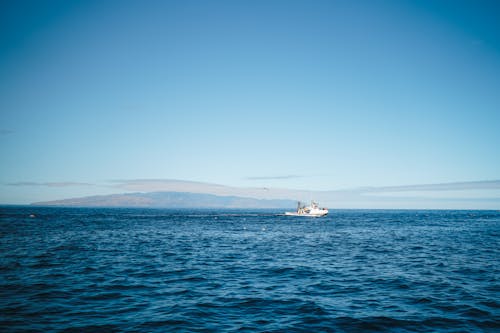 White Boat on Sea Under the Blue Sky