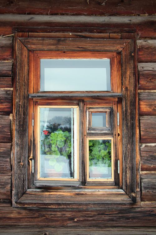 Free Charming rustic wooden window with geraniums at Yasnaya Polyana, Russia. Captures countryside charm. Stock Photo