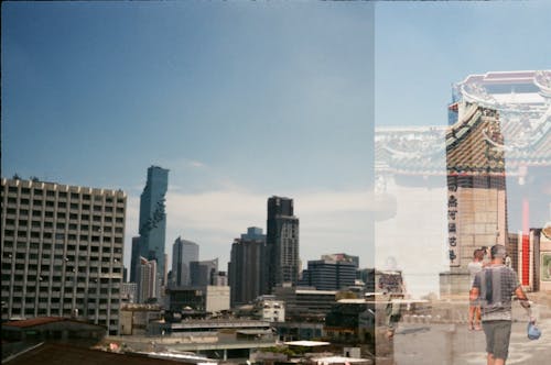 Free Double Exposure of a Cityscape of Bangkok, Thailand and Traditional Architecture  Stock Photo