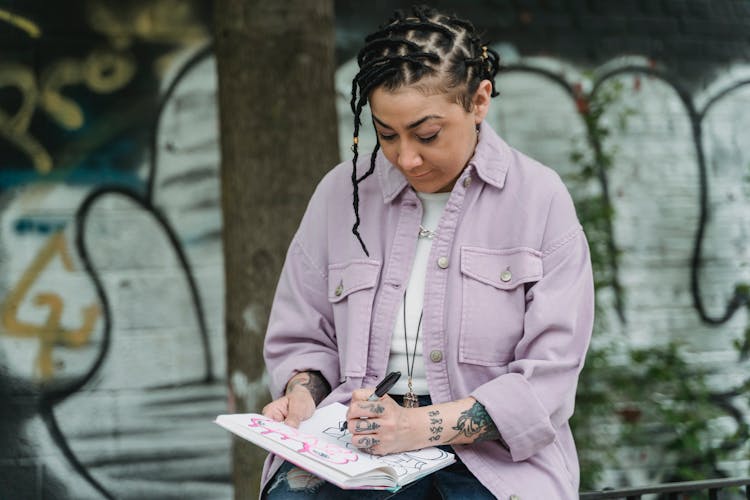 Focused Ethnic Woman Drawing Sketch