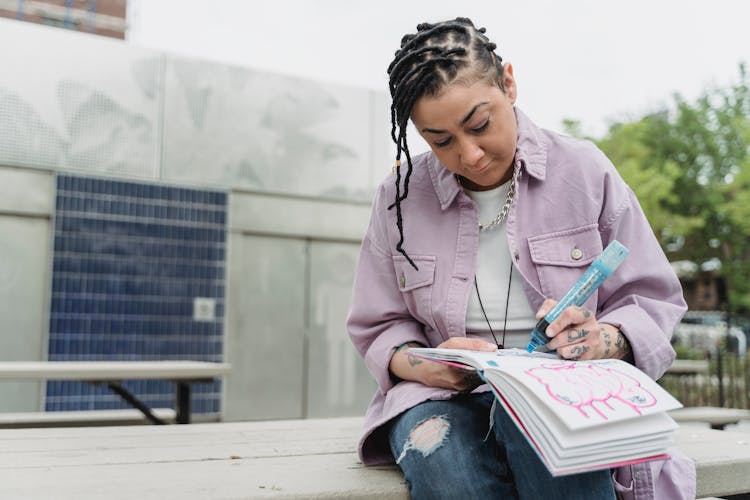 Ethnic Woman Drawing Graffiti On Paper