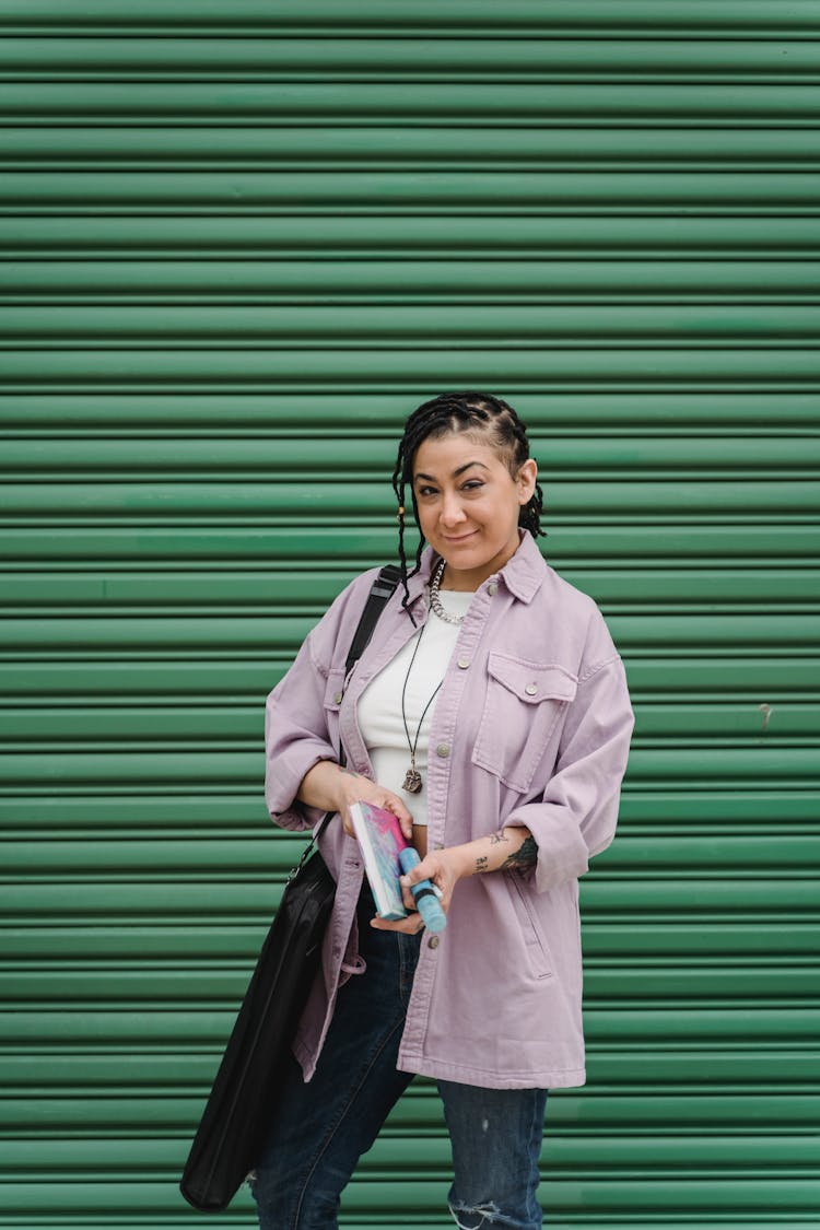 Stylish Ethnic Female Artist Standing With Art Bag And Notebook