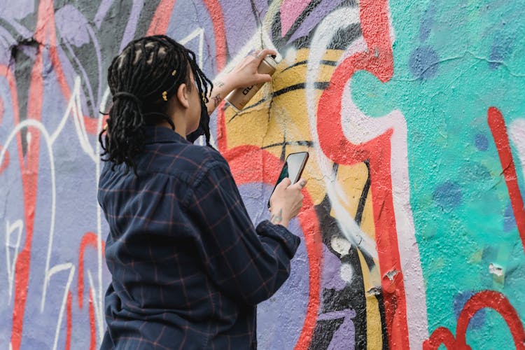 Anonymous Woman Using Spray Paint