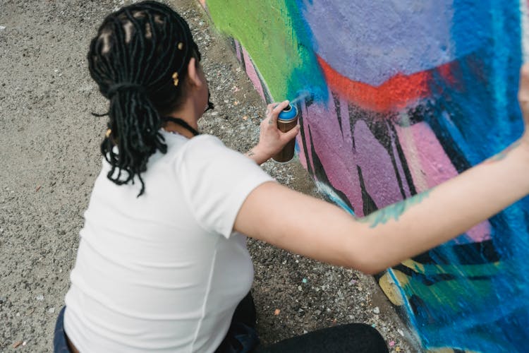 Faceless Woman Spraying Paint From Can