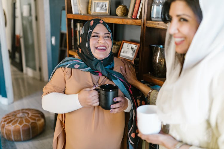 Woman Laughing While Holding A Ceramic Mug