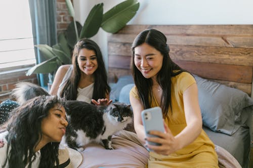 Free Close-Up Shot of Three Women Taking a Selfie From a Cellphone Stock Photo