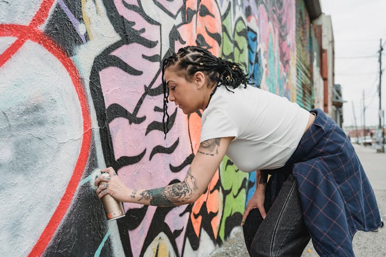 Ethnic Woman Using Spray Paint